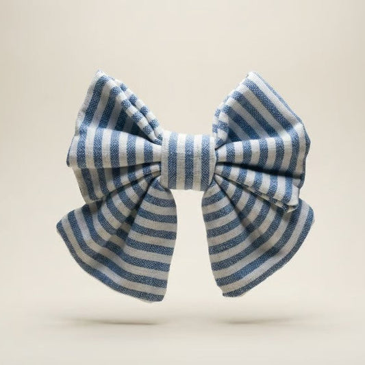 Blue and white striped bow on a beige background